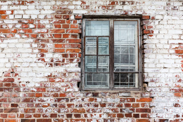 istock wooden window on weathered red brick wall painted white 819588266