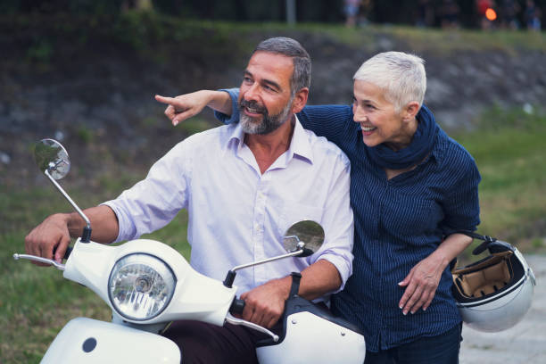 istock Happy Mature Couple Driving Scooter 819588332