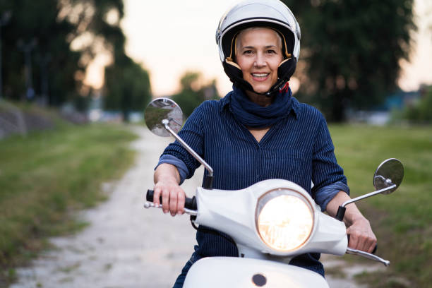 istock Happy Mature Women Driving Scooter 819590484