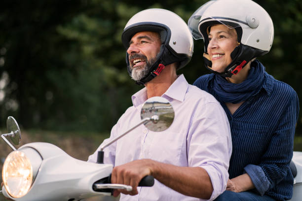 istock Happy Mature Couple Driving Scooter 819590486