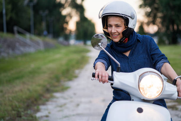 istock Happy Mature Women Driving Scooter 819590692