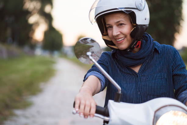 istock Happy Mature Women Driving Scooter 819590784