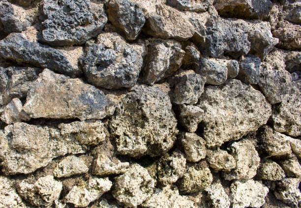 istock Natural stone background. Rustic old wall wallpaper. Rough grey stone bricks design. 819611576