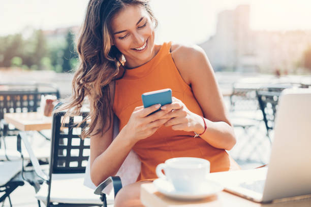 istock Elegant woman texting outdoors in the summer 819615954