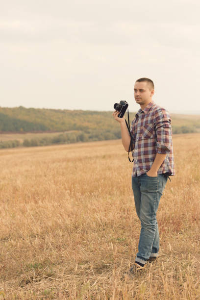 istock Attractive male photographer outdoors at sunset 819618604