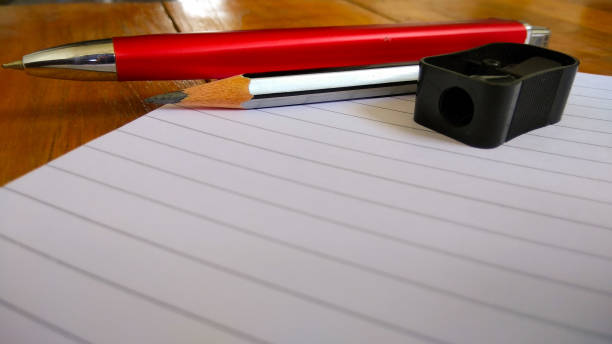 istock Notebooks, pens and pencils on wooden background 819618698