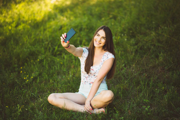 istock Girl taking selfie in the park 819626280