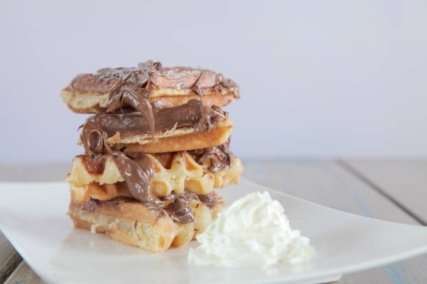 istock Chocolate waffle with vanilla whipped ice cream 819629284