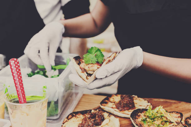 Street vendor hands making taco outdoors