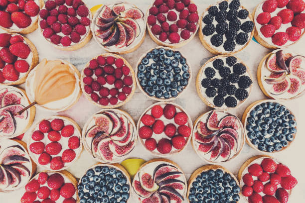 istock Fruit and Berry tarts dessert assorted top view background 819633230