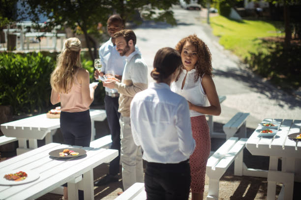 istock Friends interacting while having glass of wine in restaurant 819637174