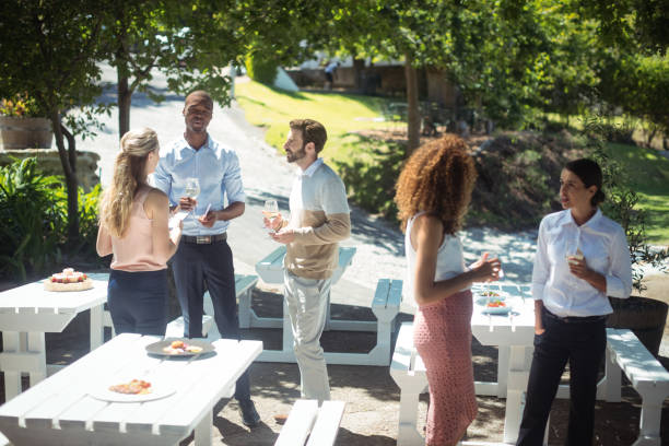 istock Friends interacting while having glass of wine in restaurant 819637276