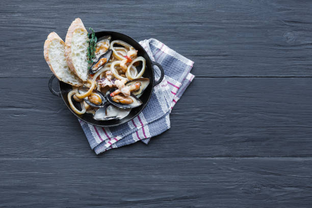 istock Seafood Stew on dark wood background, top view, copy space 819639598