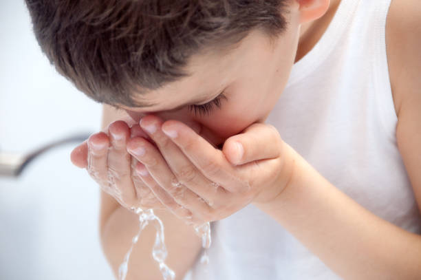 istock The child is washing his face. 819644040