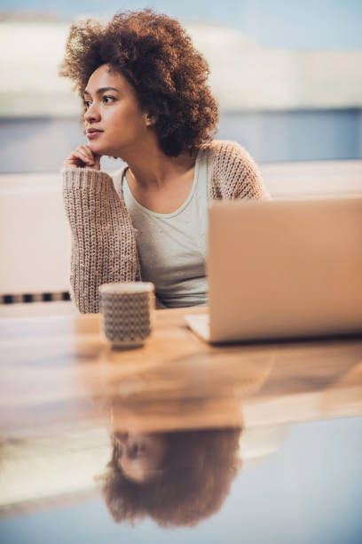 istock Beautiful black woman thinking about something while relaxing at home. 819644438