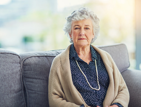 Portrait of a senior woman sitting on the sofa at home