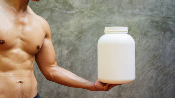 Men holding a white canned of whey protein.
