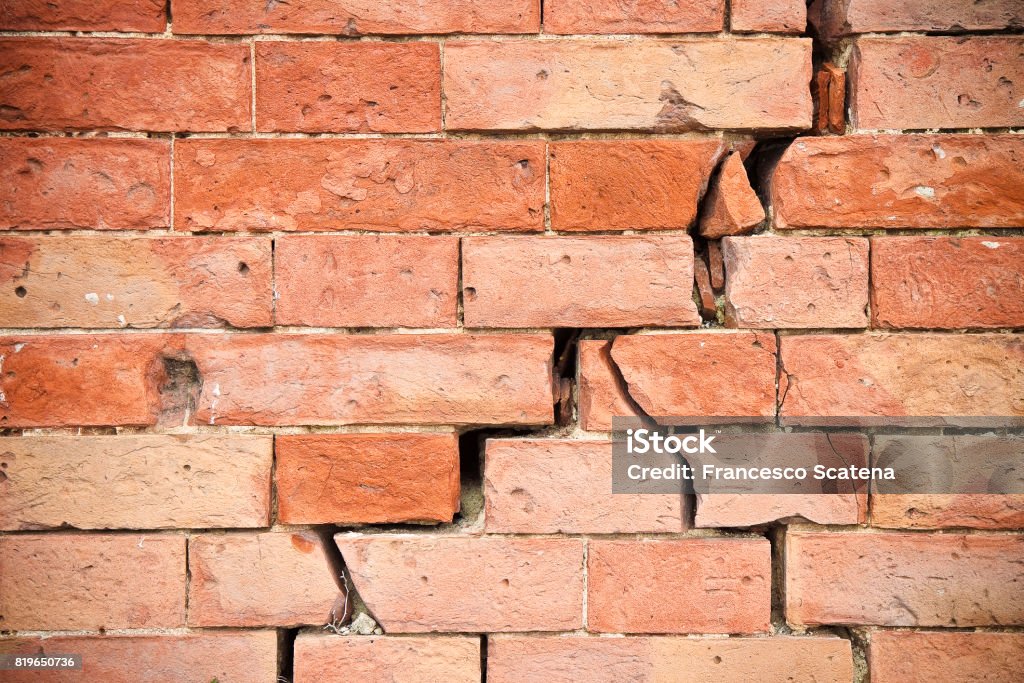 Deep crack in old brick wall - concept image Cracked Stock Photo
