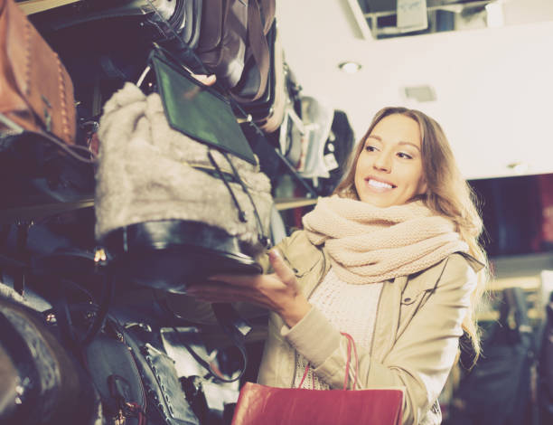 istock woman customer purchasing new hand bag in store 819662462