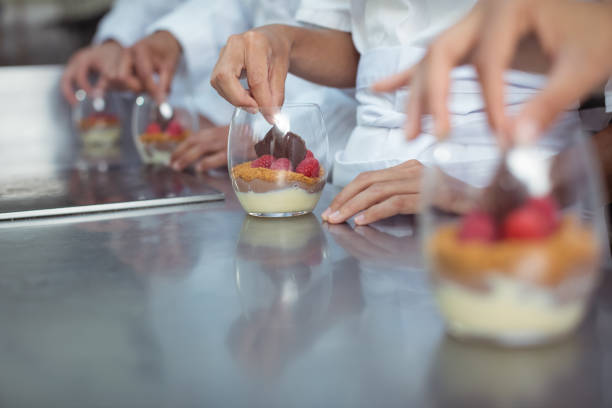 istock Chefs finishing dessert in glass at restaurant 819665556