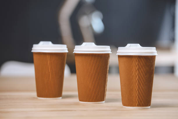 istock selective focus of disposable cups of coffee on wooden table 819665586