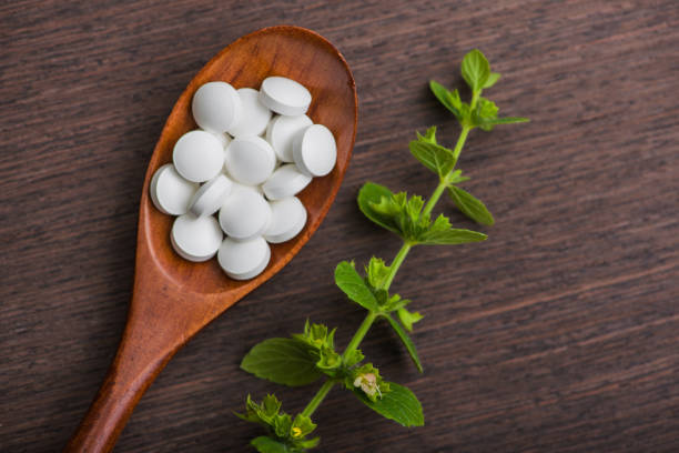 istock Organic medical pills with herbal plant 819665764