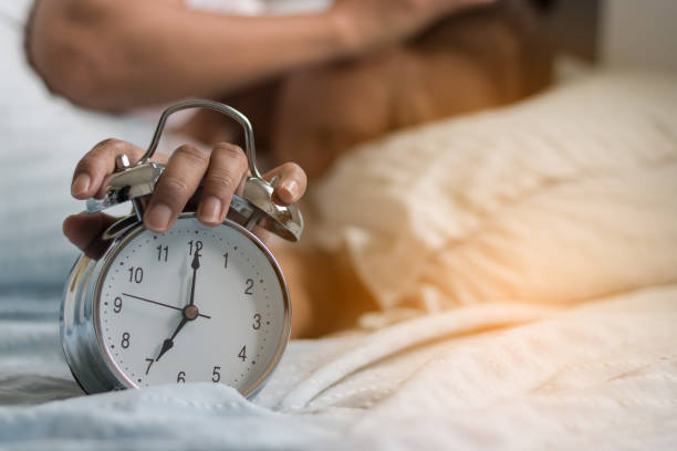 istock Clock on the bed in the morning. 819665878