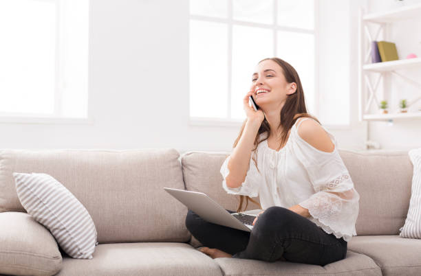 istock Girl at home with laptop and mobile 819674204
