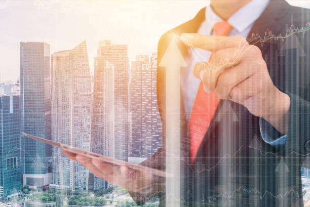 istock business man Trading concept using the tablet with financial graph on cityscape background, Double exposure style 819674428