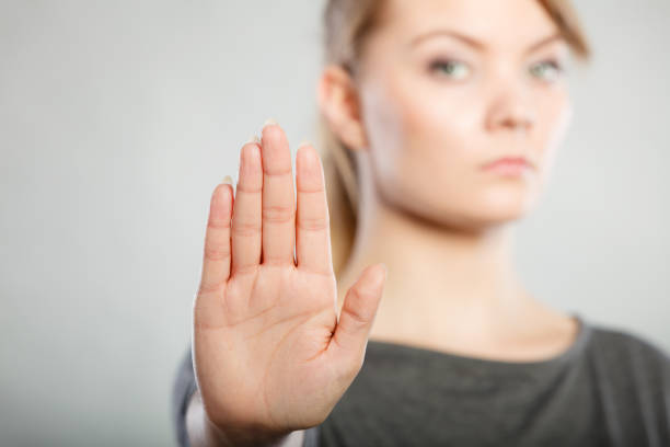 istock Female shows stop sign by her hand. 819686940