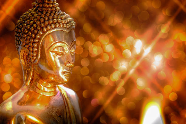 istock Selective focus of buddha statue with soft lighting effect and glitter abstract background with bokeh defocused lights. Concept of peace, meditation, hope and relaxation 819695306