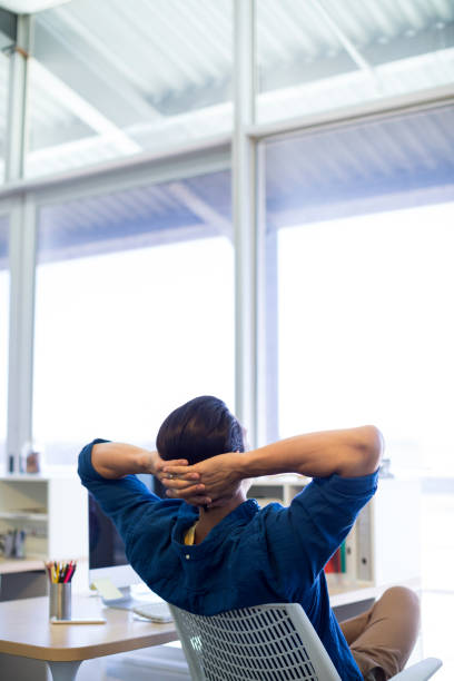 istock Male executive relaxing at his desk 819699442