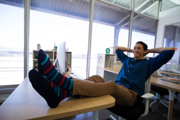 istock Male executive relaxing at his desk 819699656