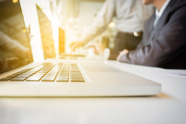istock business Teamwork looking at report and having a discussion in office. 819708938