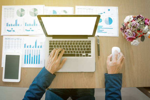 istock Businessman working at office desk and using a digital tablet, computer, laptop and many documen new project plan of business. 819709090