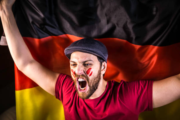 istock German fan holding the national flag 819716490