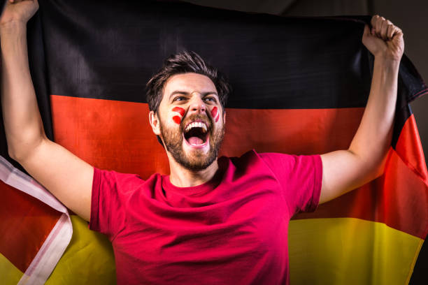 istock German fan holding the national flag 819716494