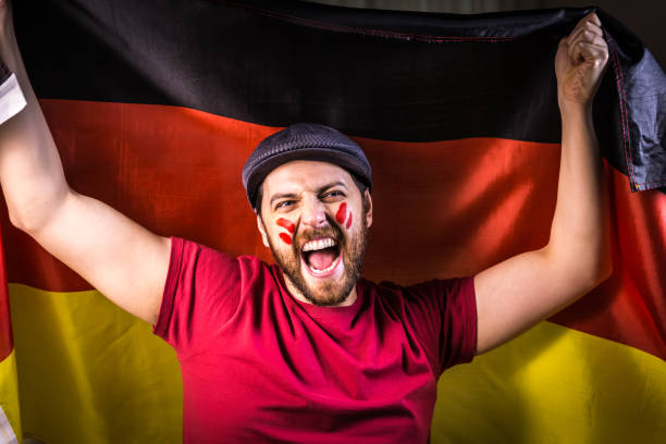 istock German fan holding the national flag 819716508