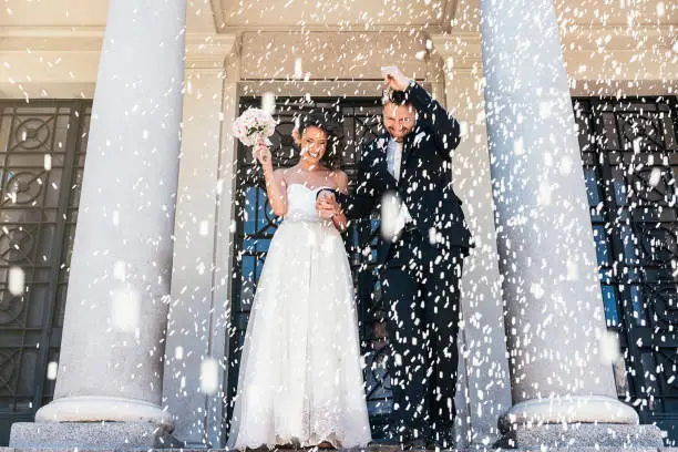 Newly married couple leaving the church.