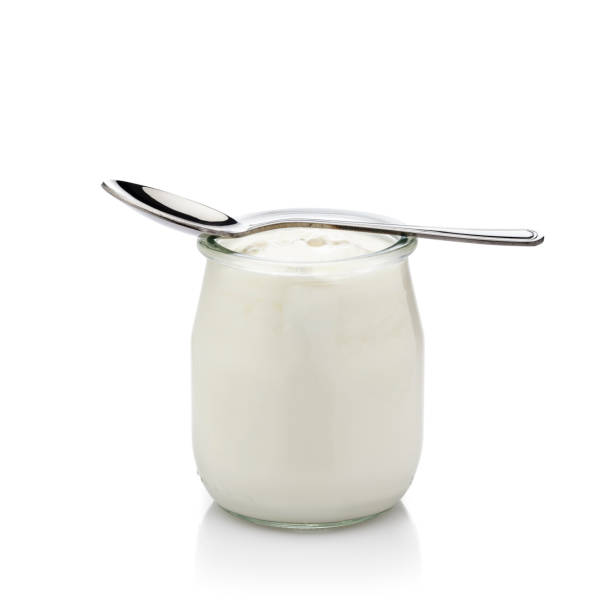 istock Yogurt in a glass container isolated on white background 819720186