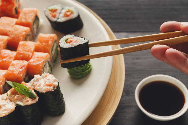 istock Eating sushi and rolls in japanese restaurant 819723176