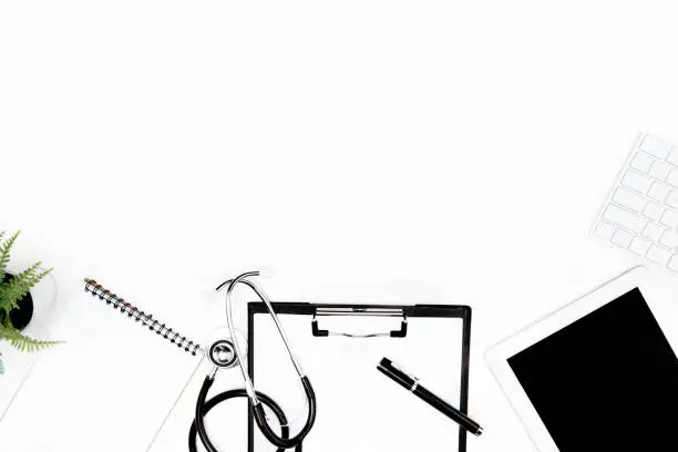 Photo of flat lay with stethoscope, clipboard, empty notebook and digital devices isolated on white