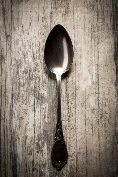 istock Old spoon on  wooden background. 819726298