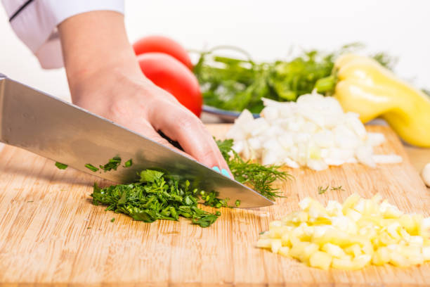 istock Cook cuts greens with a knife 819726570