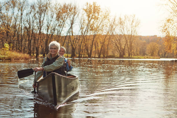 è così che facciamo la pensione - canoeing canoe senior adult couple foto e immagini stock
