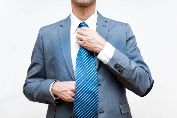 istock Young businessman adjusts his tie 819727454