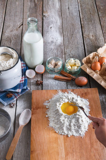 istock Woman baker makes dough with eggs, butter and flour 819730610