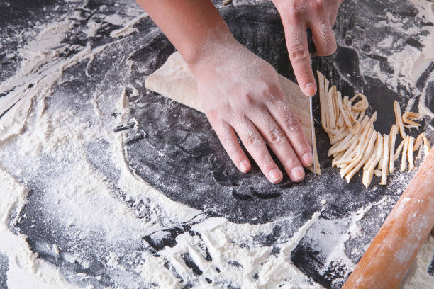 istock Cooking noodles concept on black background, sprinkled flour with copy space 819730850