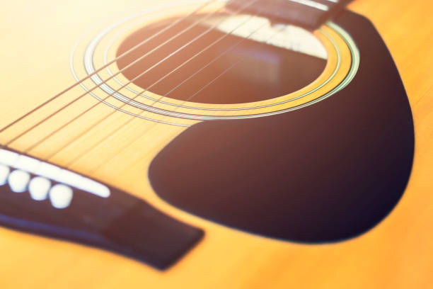 istock closeup acoustic guitar with soft-focus and over light in the background 819733952