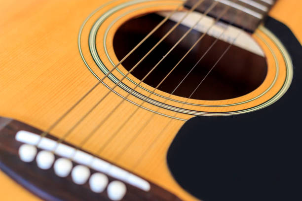istock closeup acoustic guitar with soft-focus and over light in the background 819733972